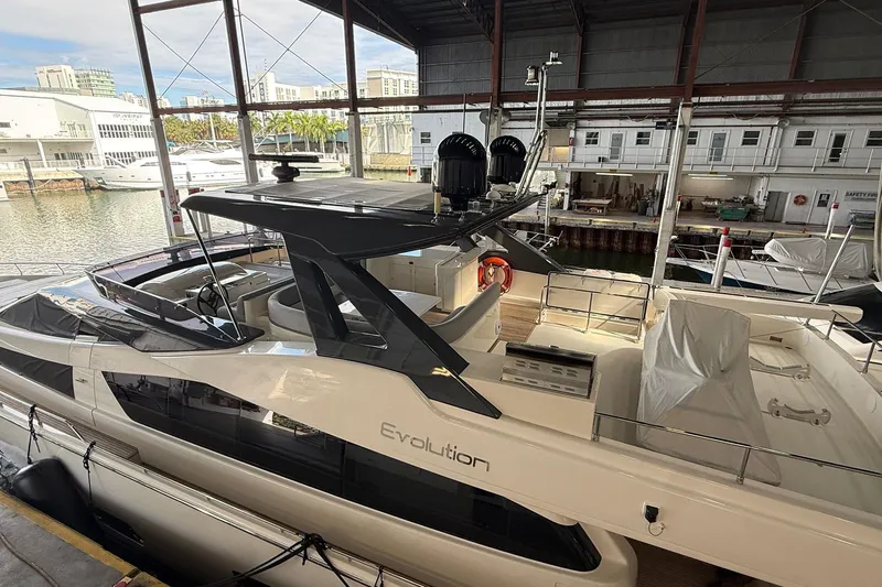 Evolution Yacht Photos Pics 2013 Ferretti Yachts 800 docked in a marina, showcasing sleek design and luxury features.