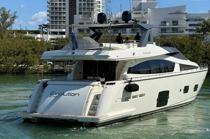 Evolution Yacht Photos Pics Luxury 2013 Ferretti Yachts 800 cruising near modern waterfront buildings.