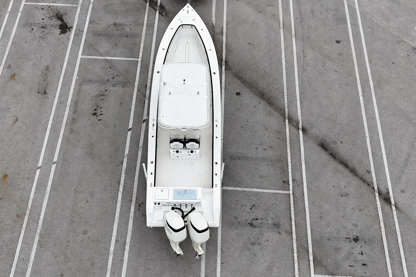 Aerial view of a 2002 Island Runner 31 boat parked on a concrete surface.