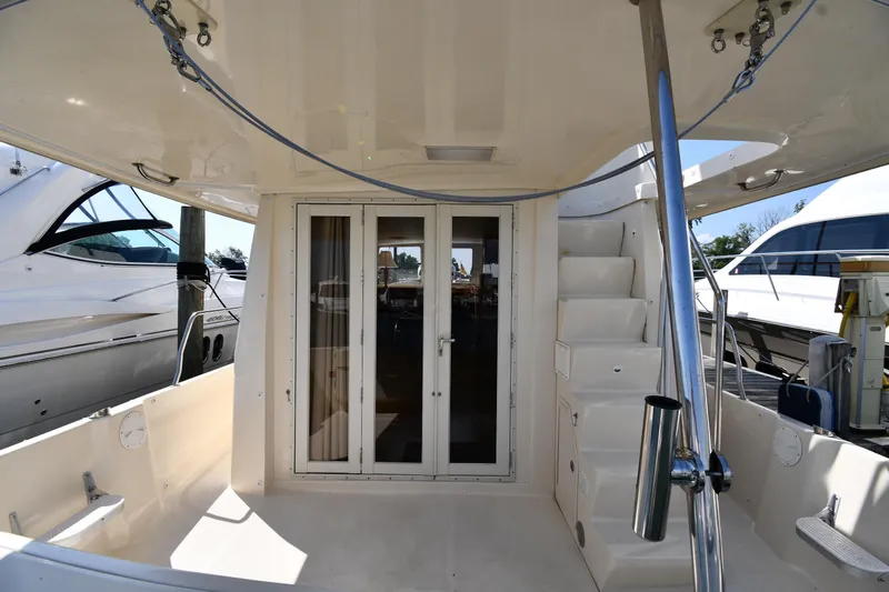Make Me Smile Yacht Photos Pics 2006 Mainship 40 Trawler aft deck with stairs and glass doors.