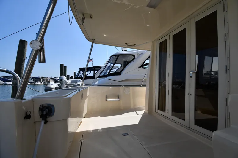 Make Me Smile Yacht Photos Pics 2006 Mainship 40 Trawler deck view with marina background.