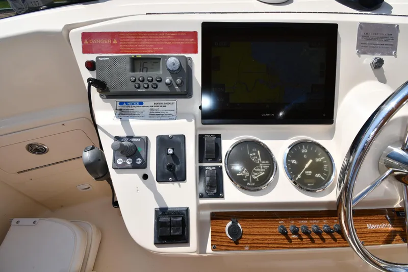 Make Me Smile Yacht Photos Pics 2006 Mainship 40 Trawler helm with navigation instruments and steering wheel.