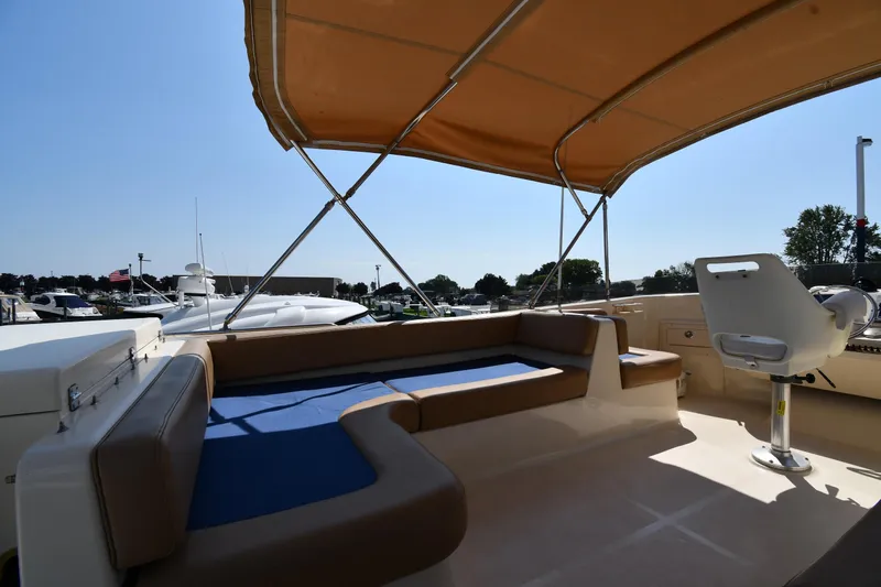 Make Me Smile Yacht Photos Pics 2006 Mainship 40 Trawler with shaded seating area and helm, docked under clear sky.