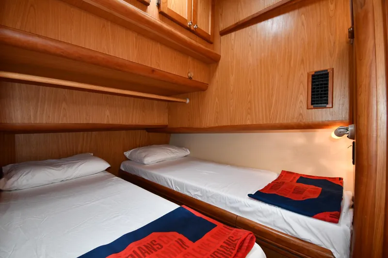 Make Me Smile Yacht Photos Pics Cozy twin cabin in 2006 Mainship 40 Trawler with wooden interior and bedding.
