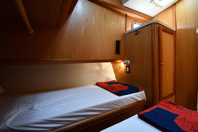 Make Me Smile Yacht Photos Pics Cozy cabin interior of 2006 Mainship 40 Trawler with wooden paneling and twin beds.