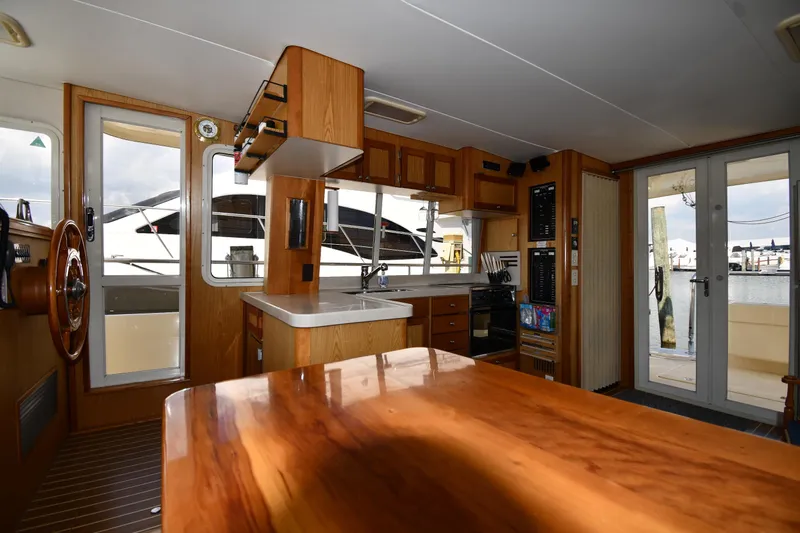 Make Me Smile Yacht Photos Pics Interior of 2006 Mainship 40 Trawler with wooden cabinetry and nautical decor.