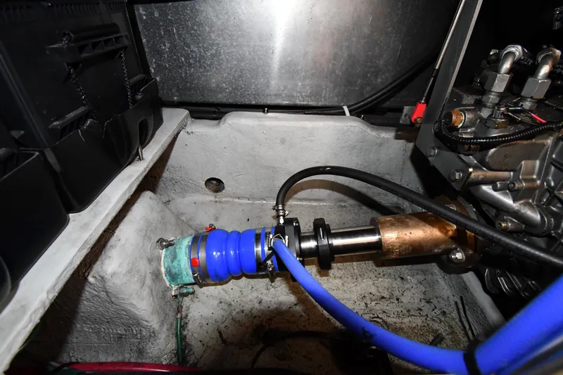 Make Me Smile Yacht Photos Pics Engine compartment of a 2006 Mainship 40 Trawler, featuring hoses and mechanical components.