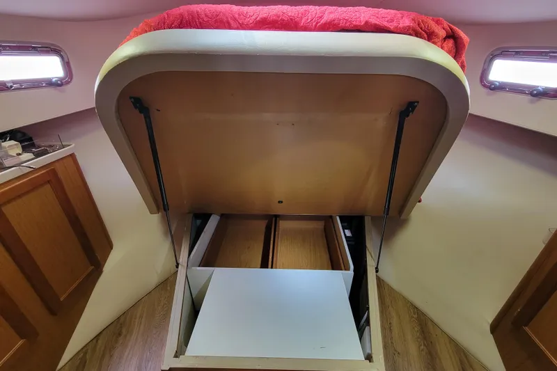 Make Me Smile Yacht Photos Pics 2006 Mainship 40 Trawler interior with under-bed storage compartment open.