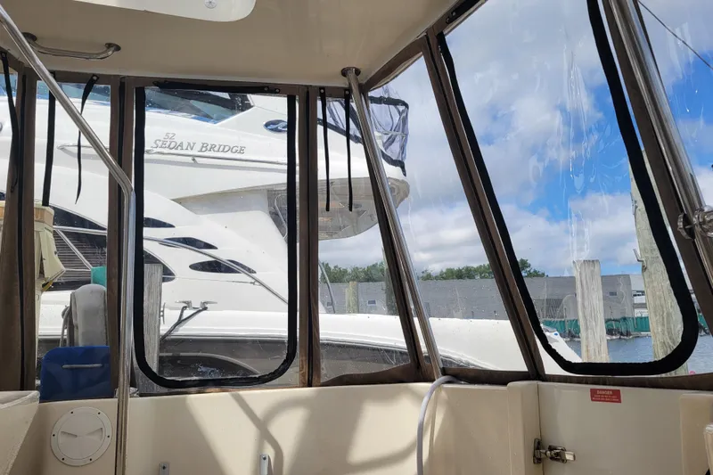 Make Me Smile Yacht Photos Pics 2006 Mainship 40 Trawler interior view with docked boats outside.