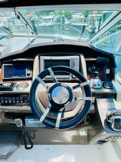 Seas The Day Yacht Photos Pics 2012 Cruisers 350 Express helm with modern navigation equipment.