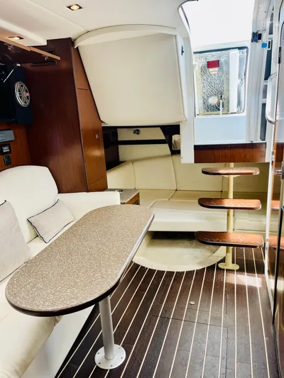 Seas The Day Yacht Photos Pics 2012 Cruisers 350 Express cabin interior with modern seating, table, and wooden steps.