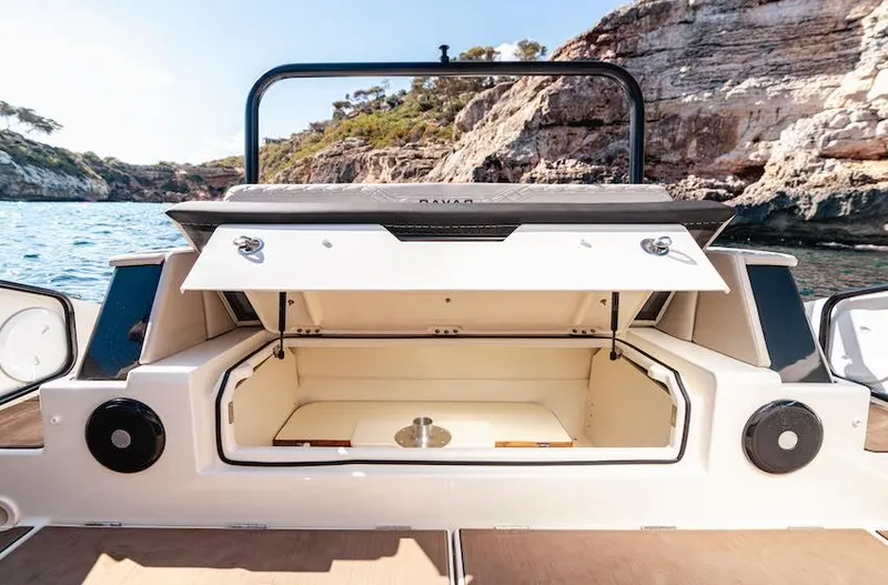  Yacht Photos Pics Open storage compartment on 2025 Navan S30 boat, with scenic rocky coastline backdrop.