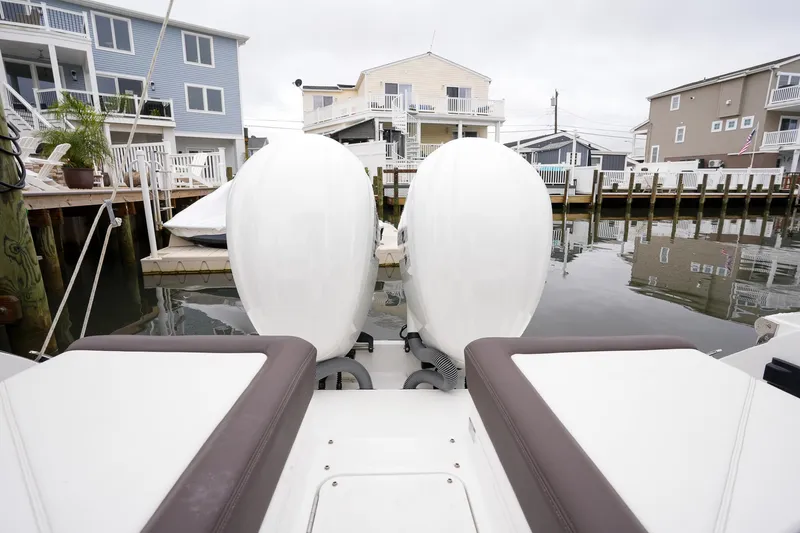 Plane To Sea Yacht Photos Pics 2022 Cobalt R8 boat with dual engines docked near waterfront homes.