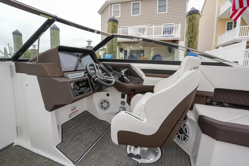 Plane To Sea Yacht Photos Pics 2022 Cobalt R8 boat interior with modern dashboard and comfortable seating.