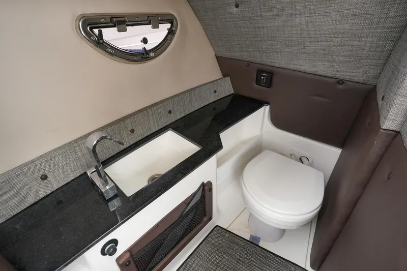Plane To Sea Yacht Photos Pics 2022 Cobalt R8 boat interior with sink and toilet in compact bathroom.