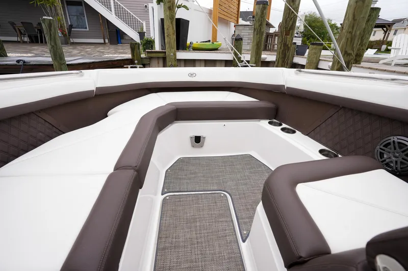 Plane To Sea Yacht Photos Pics 2022 Cobalt R8 boat interior with white and brown seating, docked at a marina.