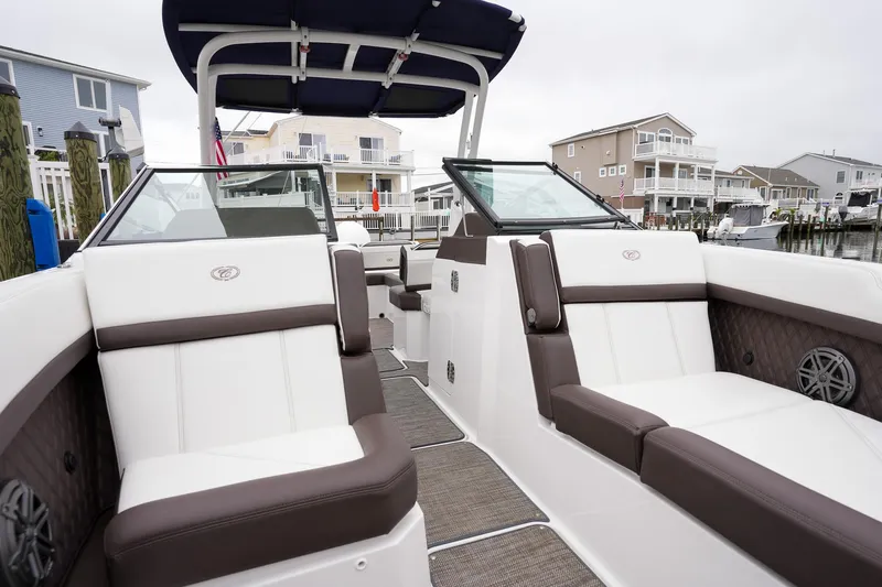 Plane To Sea Yacht Photos Pics 2022 Cobalt R8 boat interior with luxurious seating and modern design in a marina setting.