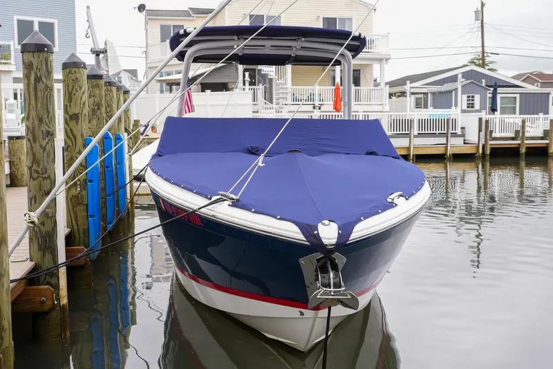 Plane To Sea Yacht Photos Pics 2022 Cobalt R8 boat docked in a marina with blue cover.