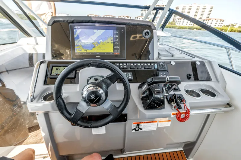  Yacht Photos Pics 2019 Jeanneau Leader 10.5 CC helm with navigation display and controls on open water.