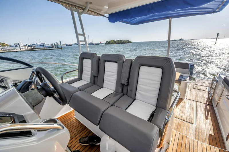  Yacht Photos Pics 2019 Jeanneau Leader 10.5 CC boat interior with plush seating and ocean view.