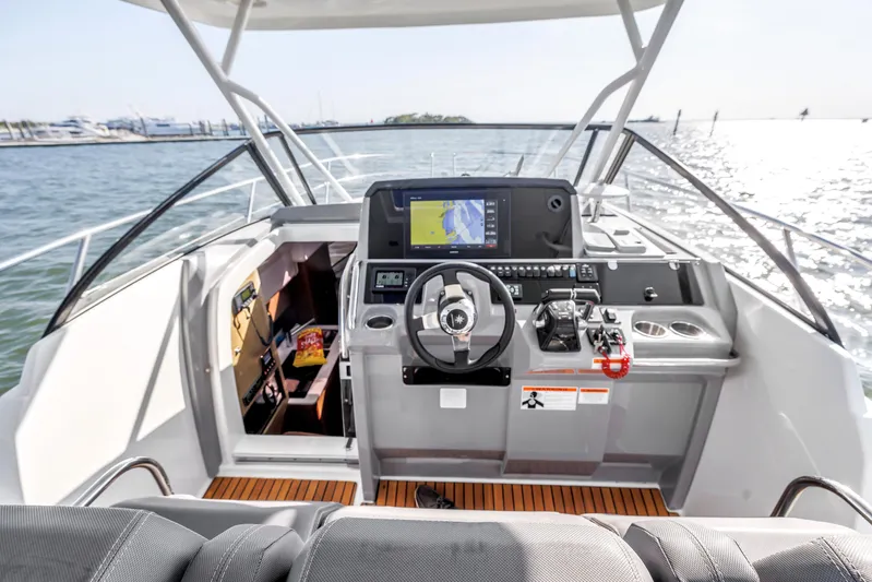  Yacht Photos Pics 2019 Jeanneau Leader 10.5 CC boat cockpit with modern navigation system and steering wheel.