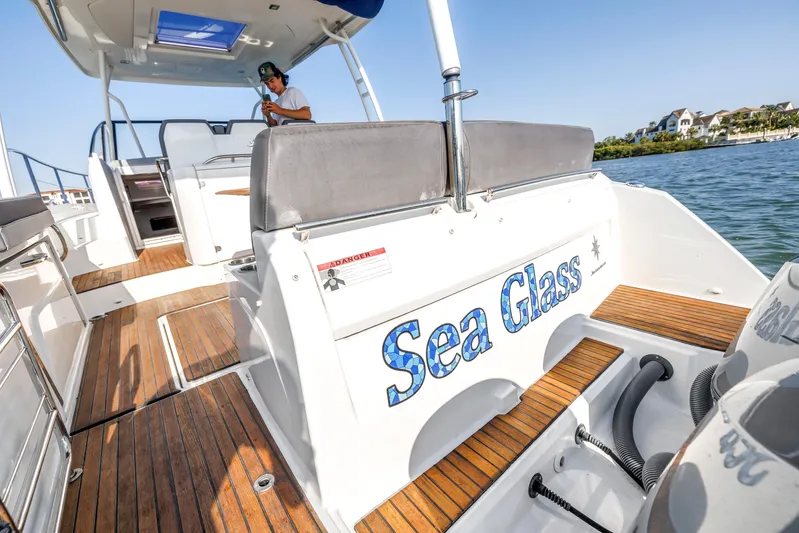  Yacht Photos Pics 2019 Jeanneau Leader 10.5 CC boat with "Sea Glass" name, docked on sunny day.