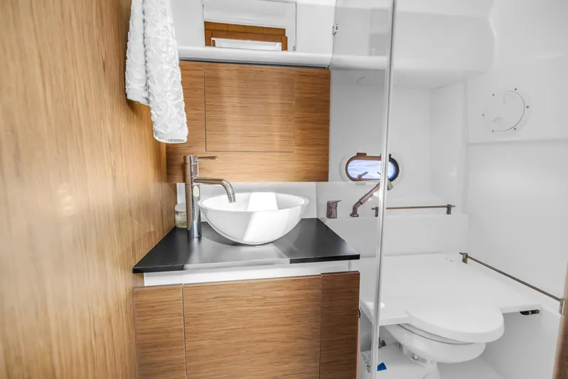  Yacht Photos Pics Modern bathroom in 2019 Jeanneau Leader 10.5 CC boat with wood cabinetry and sleek fixtures.