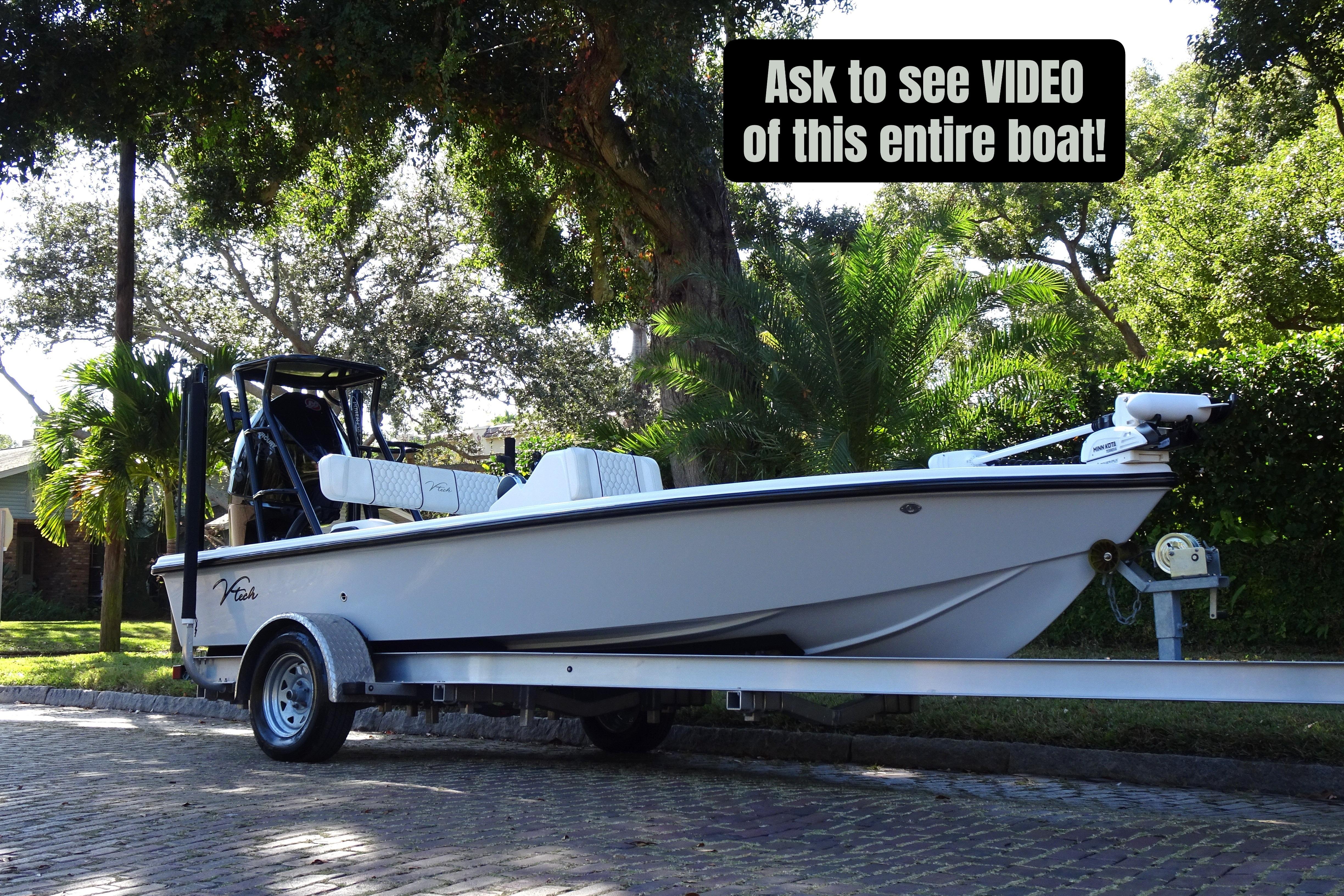 2023 Vtech 18 boat on trailer, surrounded by lush greenery, with video request sign.