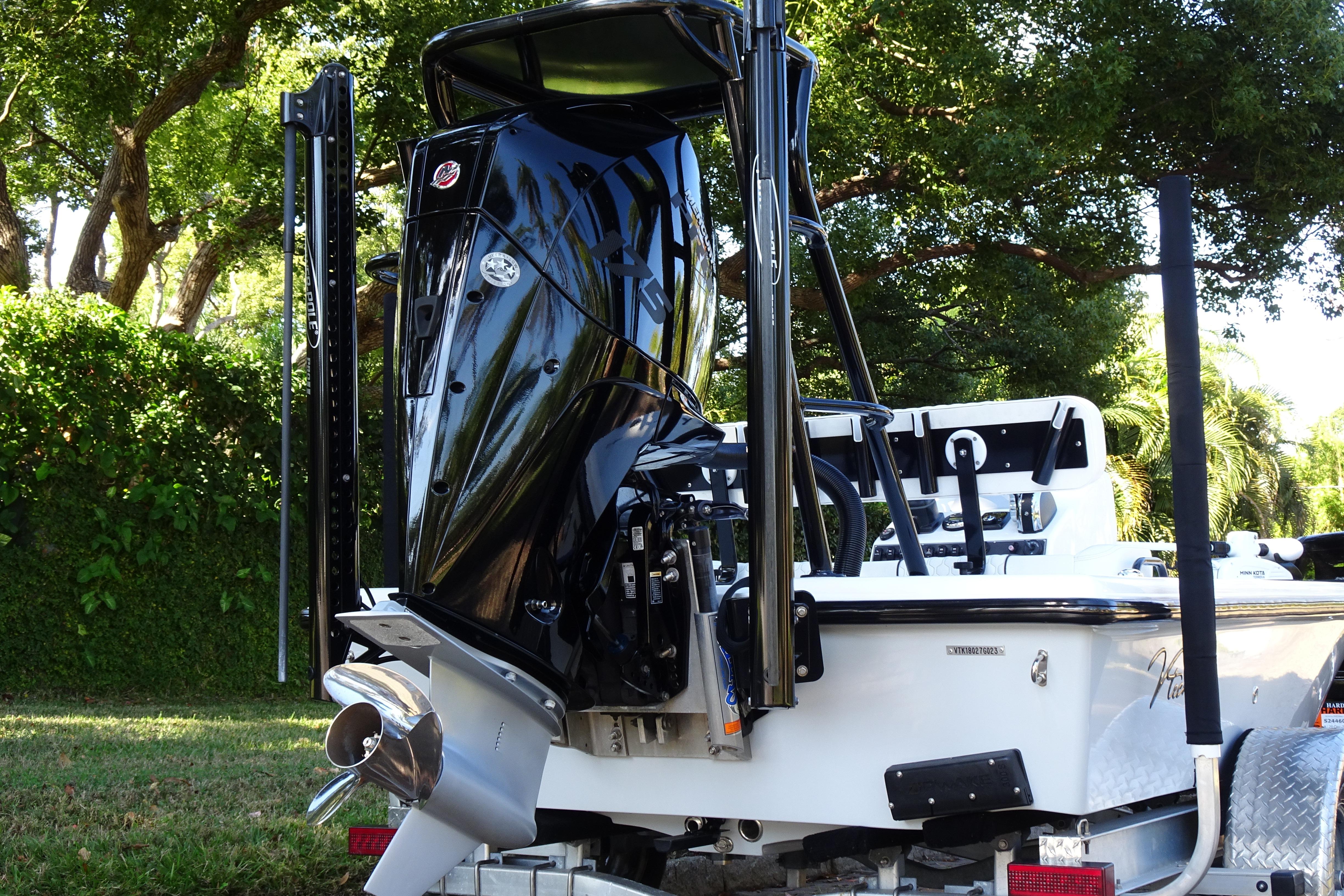 Vtech 18 boat, 2023 model, with powerful outboard motor, parked outdoors.