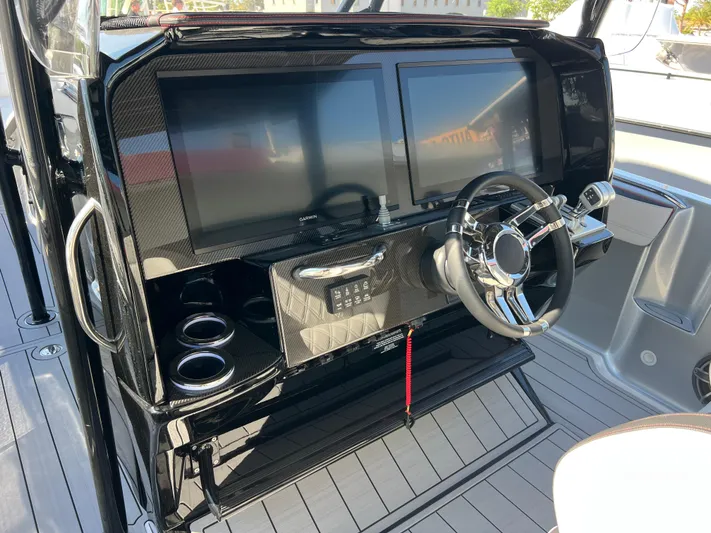  Yacht Photos Pics 2025 Nor-Tech 390 Sport Center Console dashboard with dual screens and modern steering wheel.