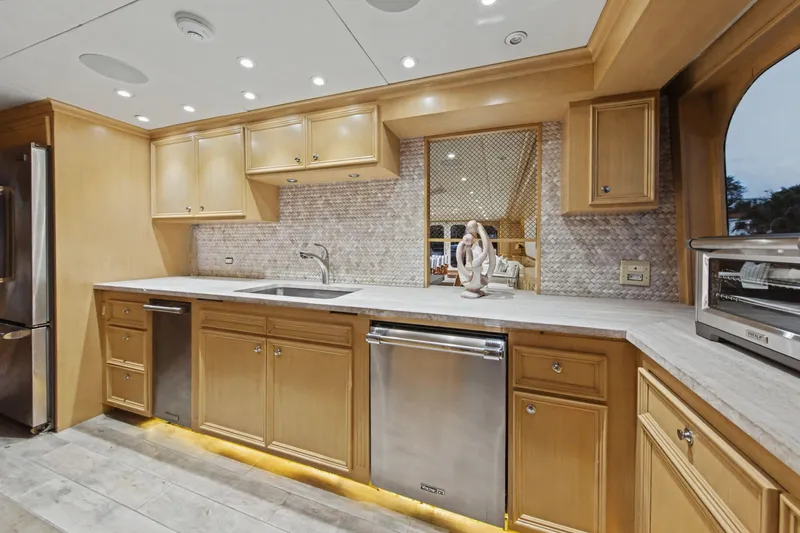 Savoir-faire Yacht Photos Pics Luxurious kitchen interior on 2002 Ocean Alexander 120 Megayacht with modern appliances.