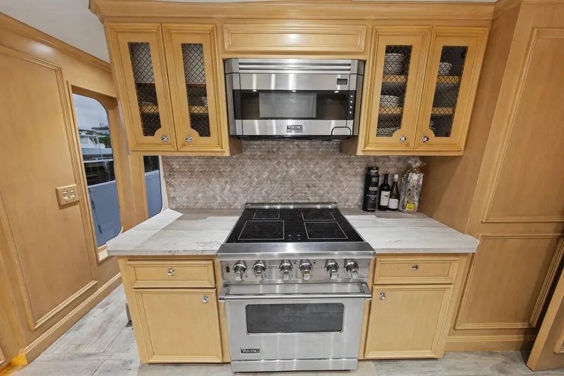 Savoir-faire Yacht Photos Pics Luxury kitchen in 2002 Ocean Alexander 120 Megayacht with Viking appliances and wooden cabinetry.
