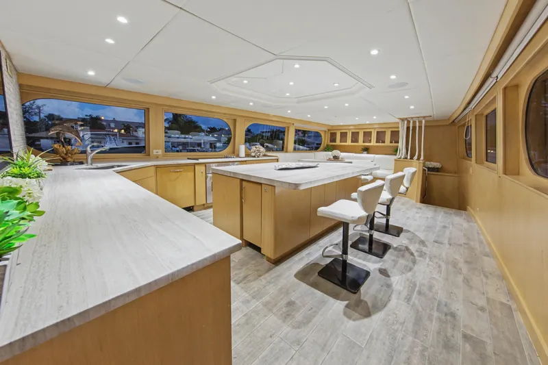 Savoir-faire Yacht Photos Pics Luxurious interior of 2002 Ocean Alexander 120 Megayacht with modern kitchen and seating area.