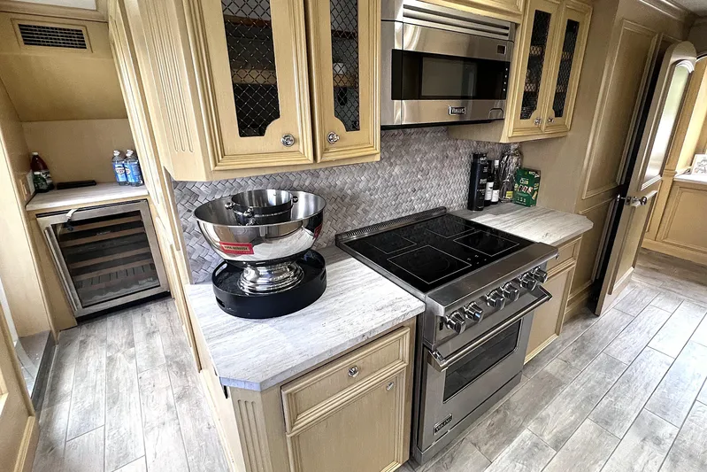 Savoir-faire Yacht Photos Pics Kitchen interior of 2002 Ocean Alexander 120 Megayacht with modern appliances and cabinetry.