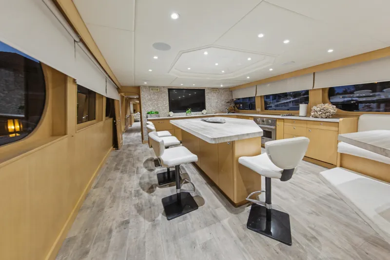 Savoir-faire Yacht Photos Pics Luxurious interior of 2002 Ocean Alexander 120 Megayacht with modern kitchen and seating.