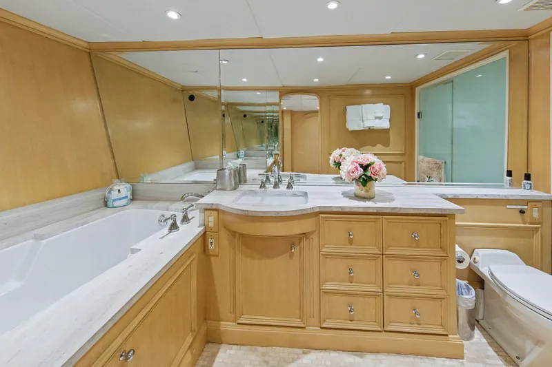 Savoir-faire Yacht Photos Pics Luxurious bathroom in 2002 Ocean Alexander 120 Megayacht with elegant wood cabinetry and marble accents.