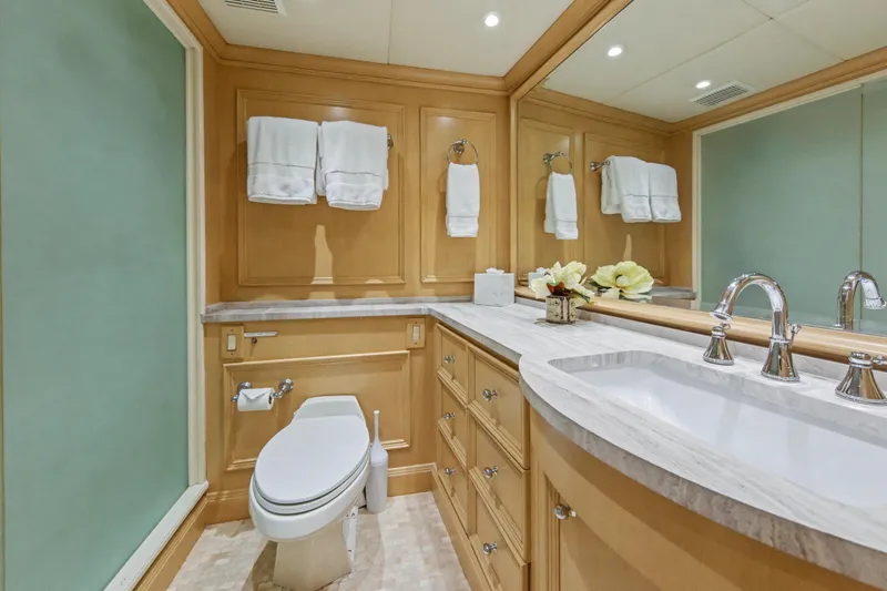 Savoir-faire Yacht Photos Pics Luxurious bathroom on 2002 Ocean Alexander 120 Megayacht with elegant fixtures and wood cabinetry.