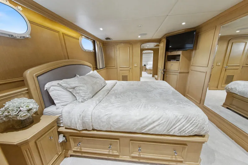 Savoir-faire Yacht Photos Pics Luxurious bedroom interior of 2002 Ocean Alexander 120 Megayacht with elegant wood paneling.