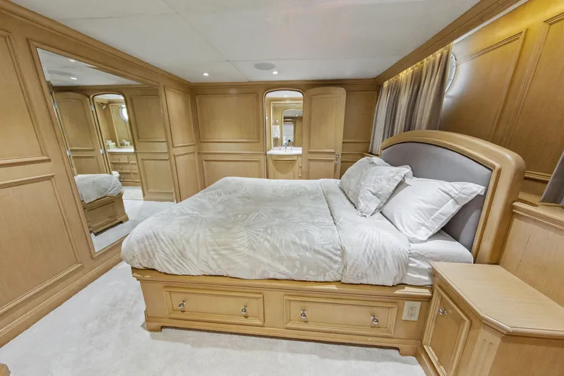 Savoir-faire Yacht Photos Pics Luxurious bedroom interior of 2002 Ocean Alexander 120 Megayacht with elegant wood paneling.