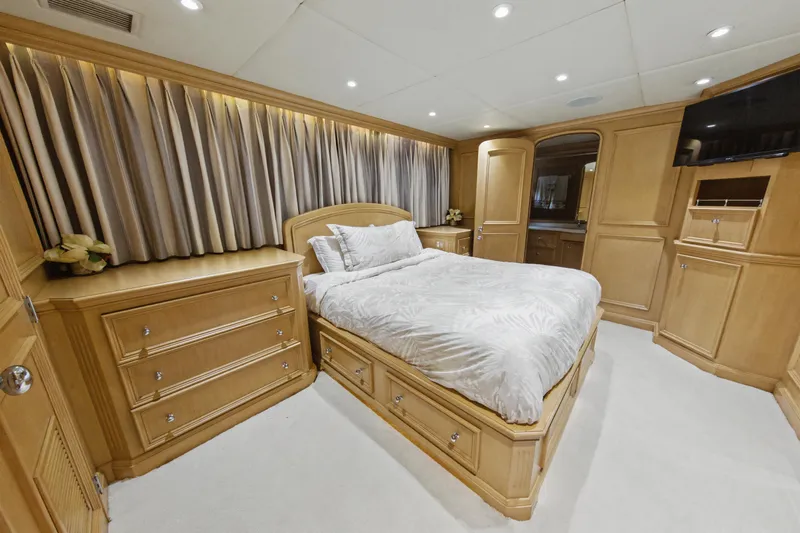 Savoir-faire Yacht Photos Pics Luxurious bedroom interior of 2002 Ocean Alexander 120 Megayacht with elegant wood furnishings.
