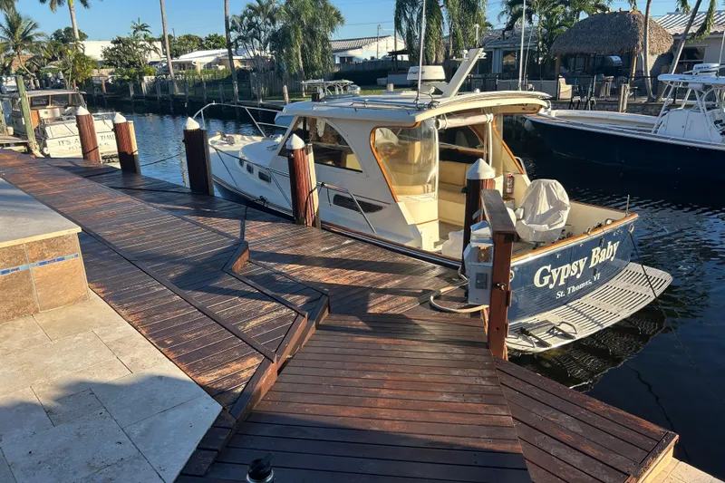 Gypsy Baby Yacht Photos Pics 2007 Legacy Yachts 32 Express docked, named "Gypsy Baby," in a sunny marina setting.