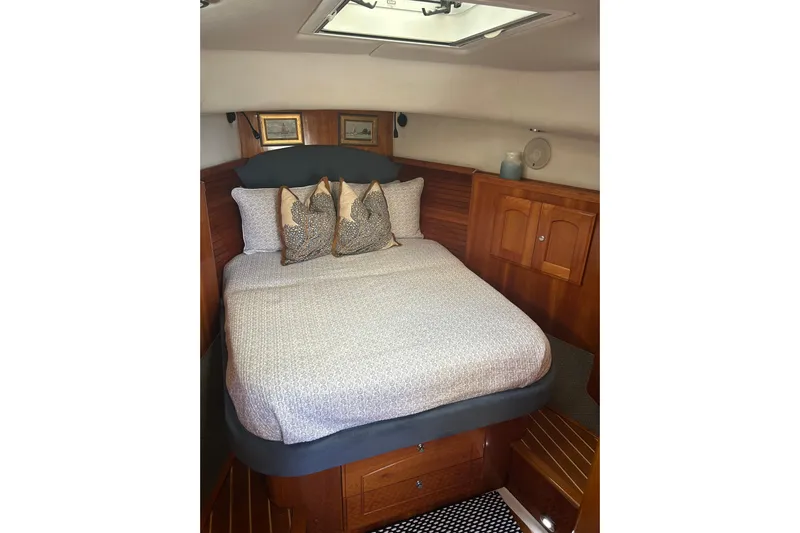 Gypsy Baby Yacht Photos Pics Cozy cabin interior of 2007 Legacy Yachts 32 Express with elegant bedding and wood finish.