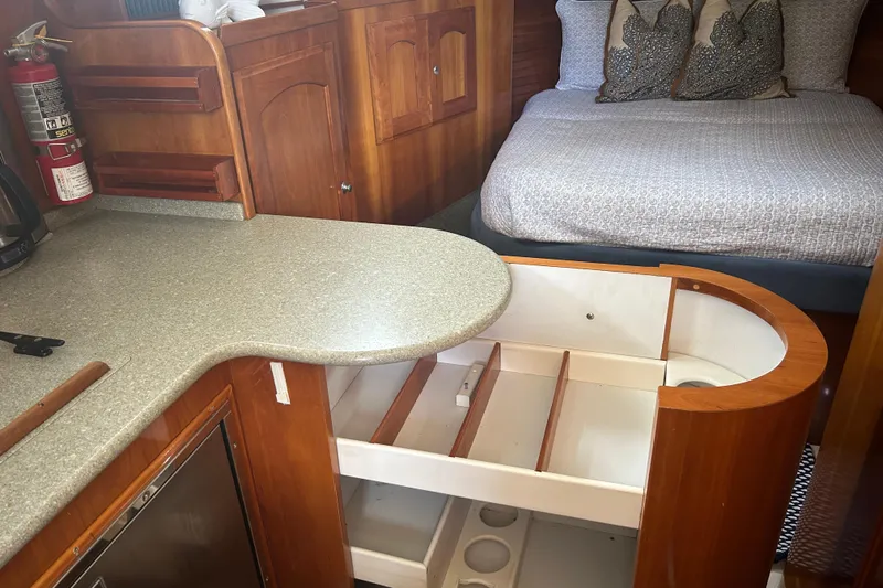 Gypsy Baby Yacht Photos Pics Interior of 2007 Legacy Yachts 32 Express with bed, storage, and kitchenette.
