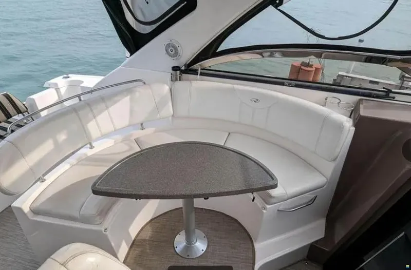  Yacht Photos Pics 2008 Regal Commodore 3760 IO boat interior with curved seating and table.