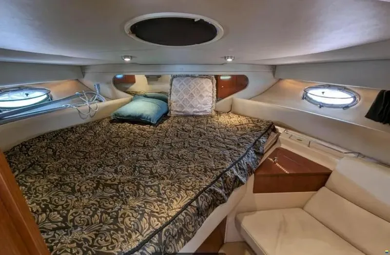  Yacht Photos Pics 2008 Regal Commodore 3760 IO cabin interior with bed, pillows, and portholes.