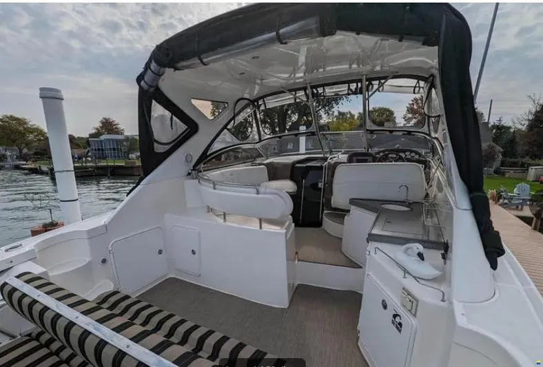  Yacht Photos Pics 2008 Regal Commodore 3760 IO boat interior with seating and helm, docked by the water.