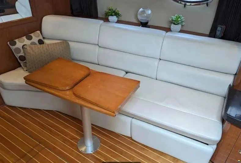  Yacht Photos Pics 2008 Regal Commodore 3760 IO interior with white leather seating and wooden table.