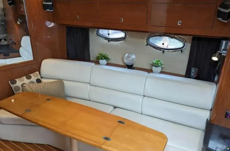  Yacht Photos Pics Interior of 2008 Regal Commodore 3760 IO yacht with plush seating and wooden table.