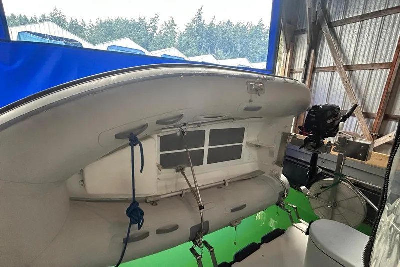 Triton Yacht Photos Pics 2011 Ranger Tugs R-29 boat with inflatable dinghy and outboard motor in a storage area.