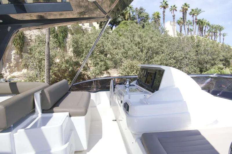 Antonina Yacht Photos Pics Luxurious 2010 Ferretti Yachts 800 with sleek outdoor seating and lush greenery backdrop.